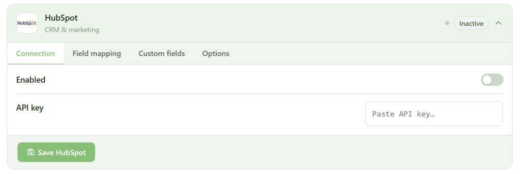 A screenshot of a HubSpot integration settings page shows tabs for Connection, Field mapping, Custom fields, and Options. The Connection tab is active, with toggles for "Enabled" and a field labeled "API key" with an empty input box. A green "Save HubSpot" button is at the bottom.